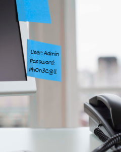 Blue sticky notes on a computer monitor showing login credentials: User: Admin, Password: ph0n3c@ll.