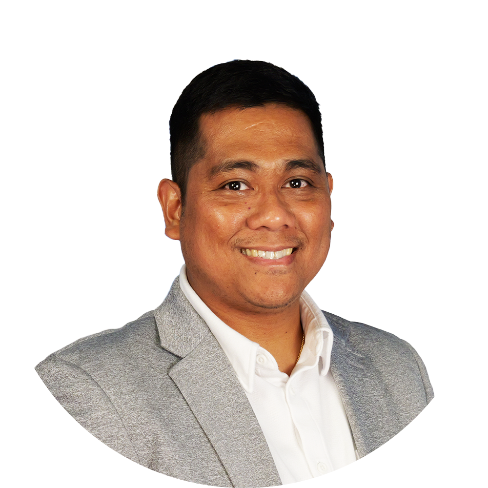 Smiling man in a light gray blazer and white shirt, headshot against a white background.