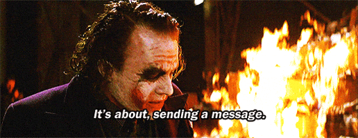 The Joker beside raging flames, caption reads: 'It's about, sending a message.'