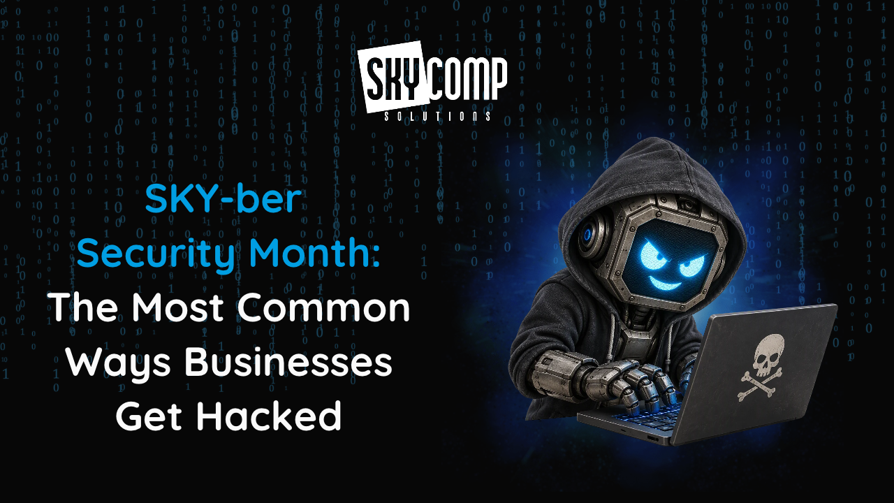 Promotional banner for SkyComp Solutions about Security Month: blue headline on the left, and a hooded cyber hacker at a laptop with a skull logo on the right.